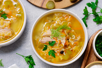 Traditional Russian rassolnik soup with pork and pickles .style rustic