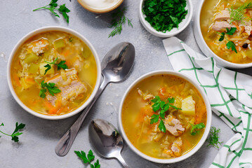 Traditional Russian rassolnik soup with pork and pickles .style rustic