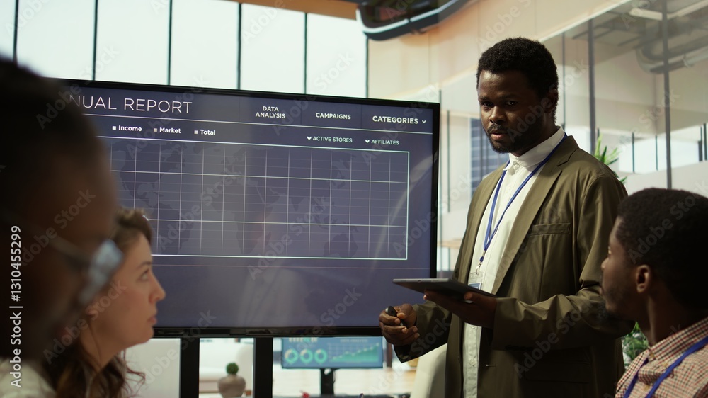 Poster coworkers engaging in a problem solving meeting at a corporation, using an interactive board to visu