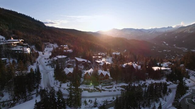 Alpine homes on hill at sunset, Whistler Mountain, aerial footage, winter scene, log cabin, luxury vacation home, mountain home. 4K 24FPS