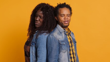 Furious offended couple having an argument and screaming at each other, dealing with marriage...