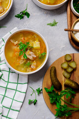 Traditional Russian rassolnik soup with pork and pickles .style rustic