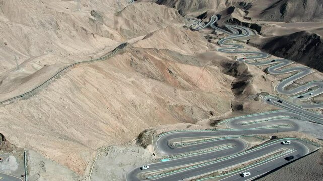 Drone view of Panlong Ancient Road like giant dragon in Tashkurgan County, Kashgar, Southern Xinjiang, China. Aerial landscape of landmark on Pamir plateau, 4k real time footage, travel concept.