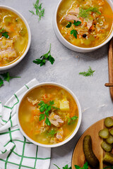 Traditional Russian rassolnik soup with pork and pickles .style rustic
