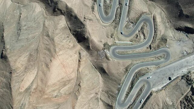 Drone view of Panlong Ancient Road like giant dragon in Tashkurgan County, Kashgar, Southern Xinjiang, China. Aerial landscape of landmark on Pamir plateau, 4k real time footage, travel concept.