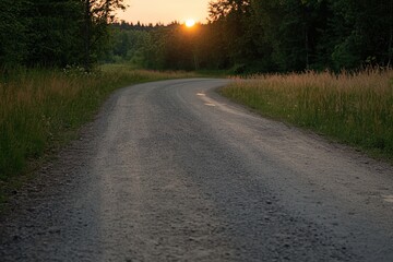 Fototapeta premium Sunset descends on a winding dirt road surrounded by lush greenery in a tranquil rural setting