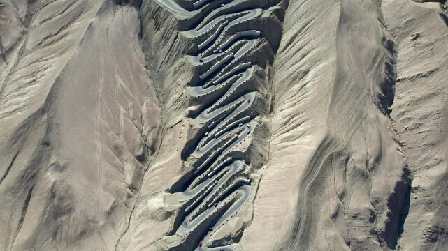 Drone view of Panlong Ancient Road like giant dragon in Tashkurgan County, Kashgar, Southern Xinjiang, China. Aerial landscape of landmark on Pamir plateau, 4k real time footage, travel concept.