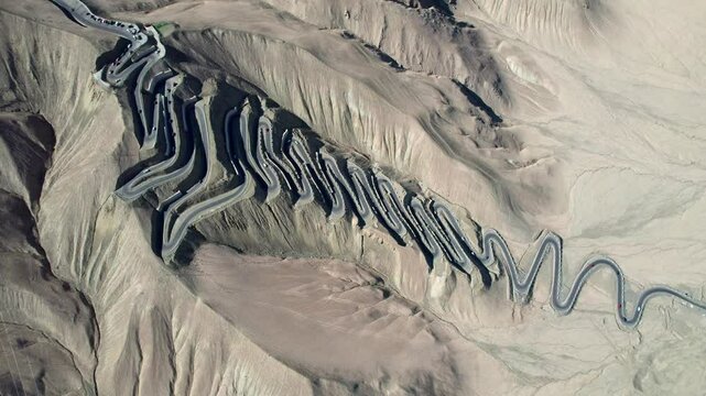 Drone view of Panlong Ancient Road like giant dragon in Tashkurgan County, Kashgar, Southern Xinjiang, China. Aerial landscape of landmark on Pamir plateau, 4k real time footage, travel concept.