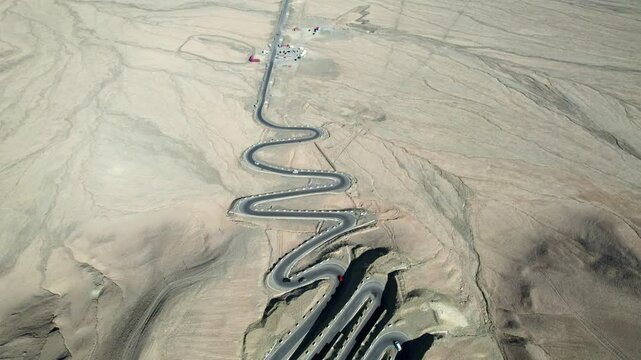 Drone view of Panlong Ancient Road like giant dragon in Tashkurgan County, Kashgar, Southern Xinjiang, China. Aerial landscape of landmark on Pamir plateau, 4k real time footage, travel concept.
