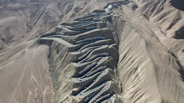 Drone view of Panlong Ancient Road like giant dragon in Tashkurgan County, Kashgar, Southern Xinjiang, China. Aerial landscape of landmark on Pamir plateau, 4k real time footage, travel concept.