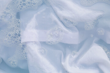 White cloth soaked in powder detergent water dissolution, washing cloth. Laundry concept