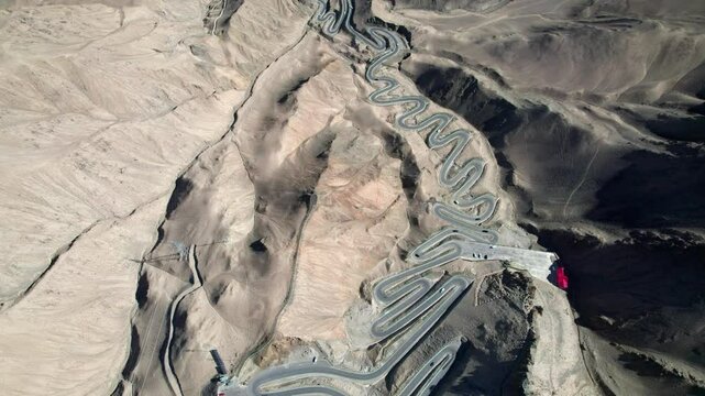 Drone view of Panlong Ancient Road like giant dragon in Tashkurgan County, Kashgar, Southern Xinjiang, China. Aerial landscape of landmark on Pamir plateau, 4k real time footage, travel concept.