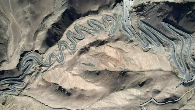 Drone view of Panlong Ancient Road like giant dragon in Tashkurgan County, Kashgar, Southern Xinjiang, China. Aerial landscape of landmark on Pamir plateau, 4k real time footage, travel concept.