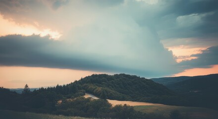Serene mountain landscape at sunset with dramatic cloudy sky
