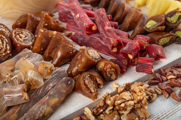 Turkish cuisine various snacks. Turkish delight, walnut sausage, pistachio sausage and fruit paste. Turkish style dried fruit paste as snack food. Local name; Lokum, Muska ve cevizli sucuk.