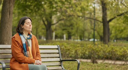 Obraz premium Caucasian female adult relaxing on park bench in autumn