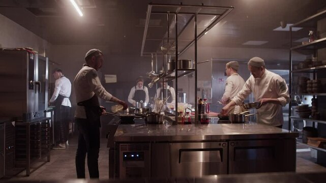 Chefs preparing food in commercial kitchen restaurant