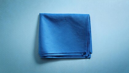 Isolated Blue Kitchen Napkin against Table Background A Vibrant Pop of Color in a Minimalistic Scene, Invoking Calm and Serenity