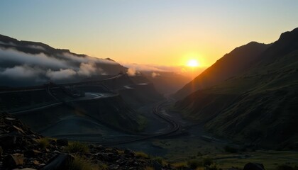 Sunrise Over Rocky Mountains with Fog and Winding Road Landscape