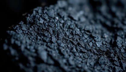 Close-Up of Fine Black Granular Material on a Dark Surface