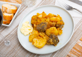 Hearty stewed veal with potato and carrot served with bread