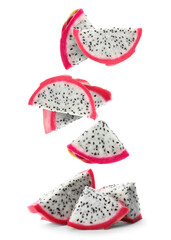 Pieces of tasty pitaya fruit falling on white background