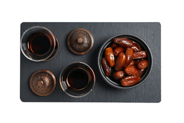 Dried dates in a bowl, black tea in Arbudu glasses, bronze bowl on a black plate, top view, isolated on white background, PNG