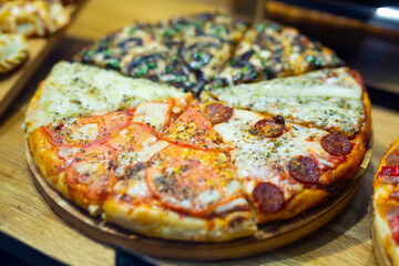 Appetizing slices of pizza on a grocery store window
