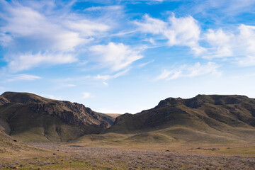 Landscape in the Ili River Canyon not far from Almaty, Kazakhstan. Rocks, steppe and a beautiful textured sky.