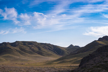 Landscape in the Ili River Canyon not far from Almaty, Kazakhstan. Rocks, steppe and a beautiful textured sky.