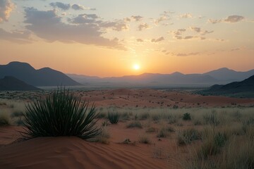 Fototapeta premium Breathtaking Sunset Over Desert Landscape with Silhouetted Mountains