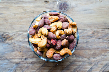 Assorted nuts in glass bowl on kitchen table