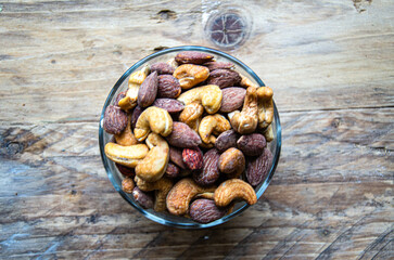 Assorted nuts in glass bowl on kitchen table