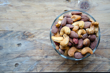 Assorted nuts in glass bowl on kitchen table