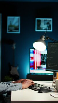 Vertical Video African american man working on PC to write code and programming in artificial intelligence and deep learning. Male IT engineer using pc to ensure cyber security, neural network. Camera