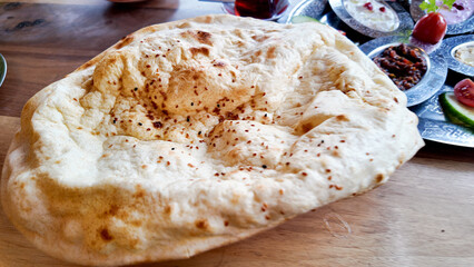 Freshly baked naan bread served with a variety of dishes