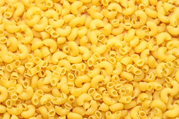 Raw horns pasta as background, top view