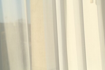 Obraz premium Beautiful white curtain on window indoors, closeup