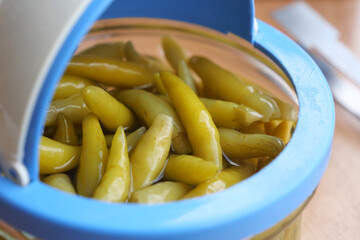 Green peppers preserved in a jar ready for use in cooking