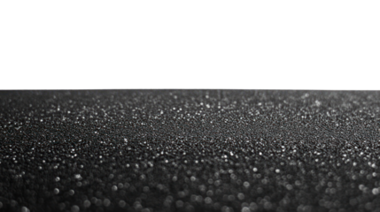 Glittering black surface with shimmering droplets reflecting light against a dark, isolated background.