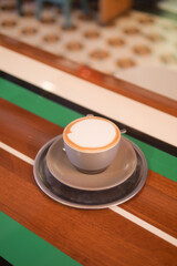 Beautifully crafted latte served on a wooden table at a cafe