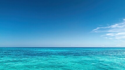 Obraz premium Vibrant Blue Ocean with Distant Boat Surrounded by Clear Sky and Calm Waves