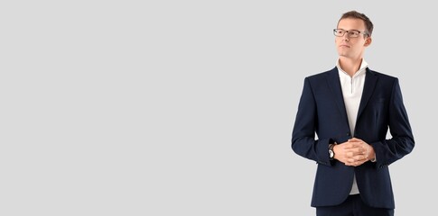 Young businessman on light background with space for text
