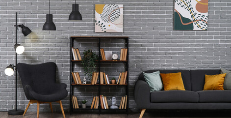 Interior of living room with armchair, sofa and bookshelf