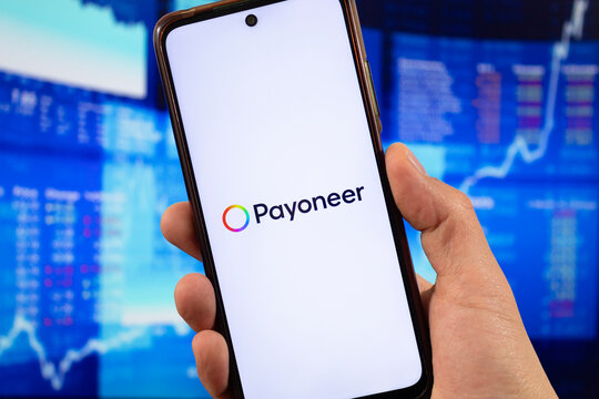 macro photo of a smartphone with payoneer global payment service logo and blurred payoneer interface at background