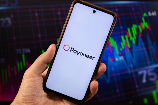 A smartphone with payoneer logo and blurred pyoneer interface at background