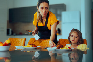 Mother Serving Daughter who Feels Like Not Eating. Exhausted mom trying to please her kid with a...
