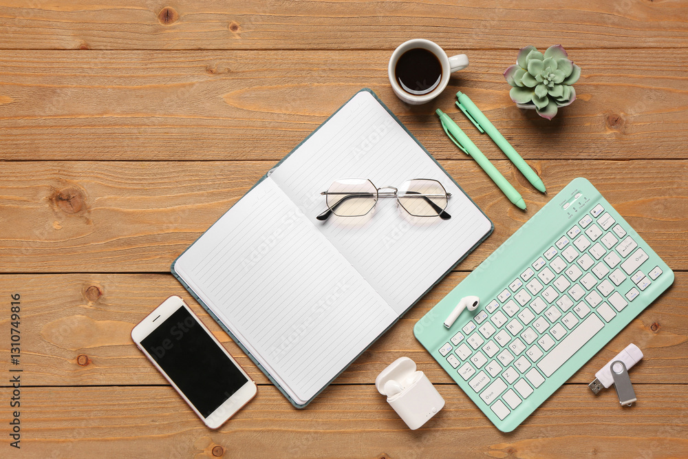 Wall mural composition with computer keyboard, cup of coffee and notebook on wooden background