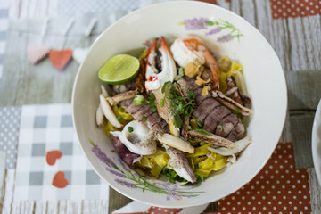 A bowl of special food of dry egg yellow noodle with crawfish, shrimp and crab, sold in Chanthaburi province, Thailand