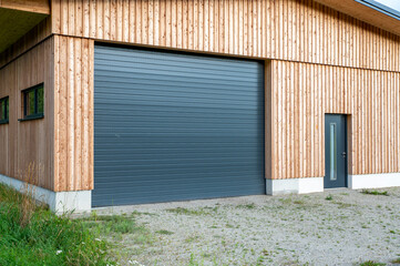 New modern rolling garage doors. Automatic gray roller shutter entrance door of an industrial...